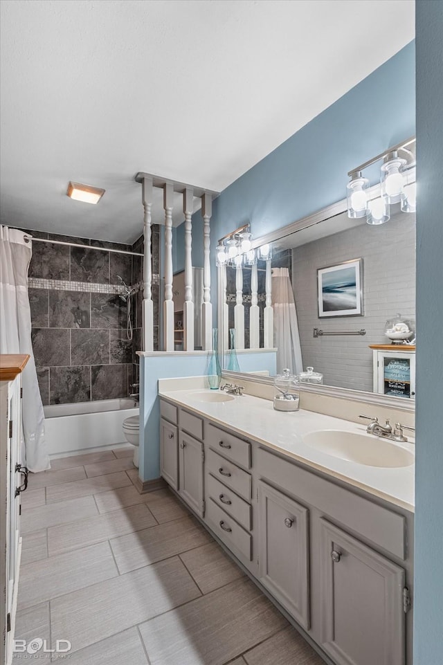 bathroom featuring a sink, shower / bath combo, toilet, and double vanity