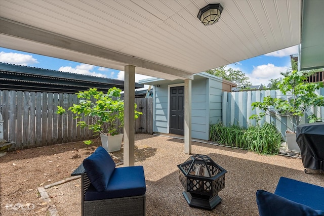 view of patio / terrace featuring a fire pit and fence