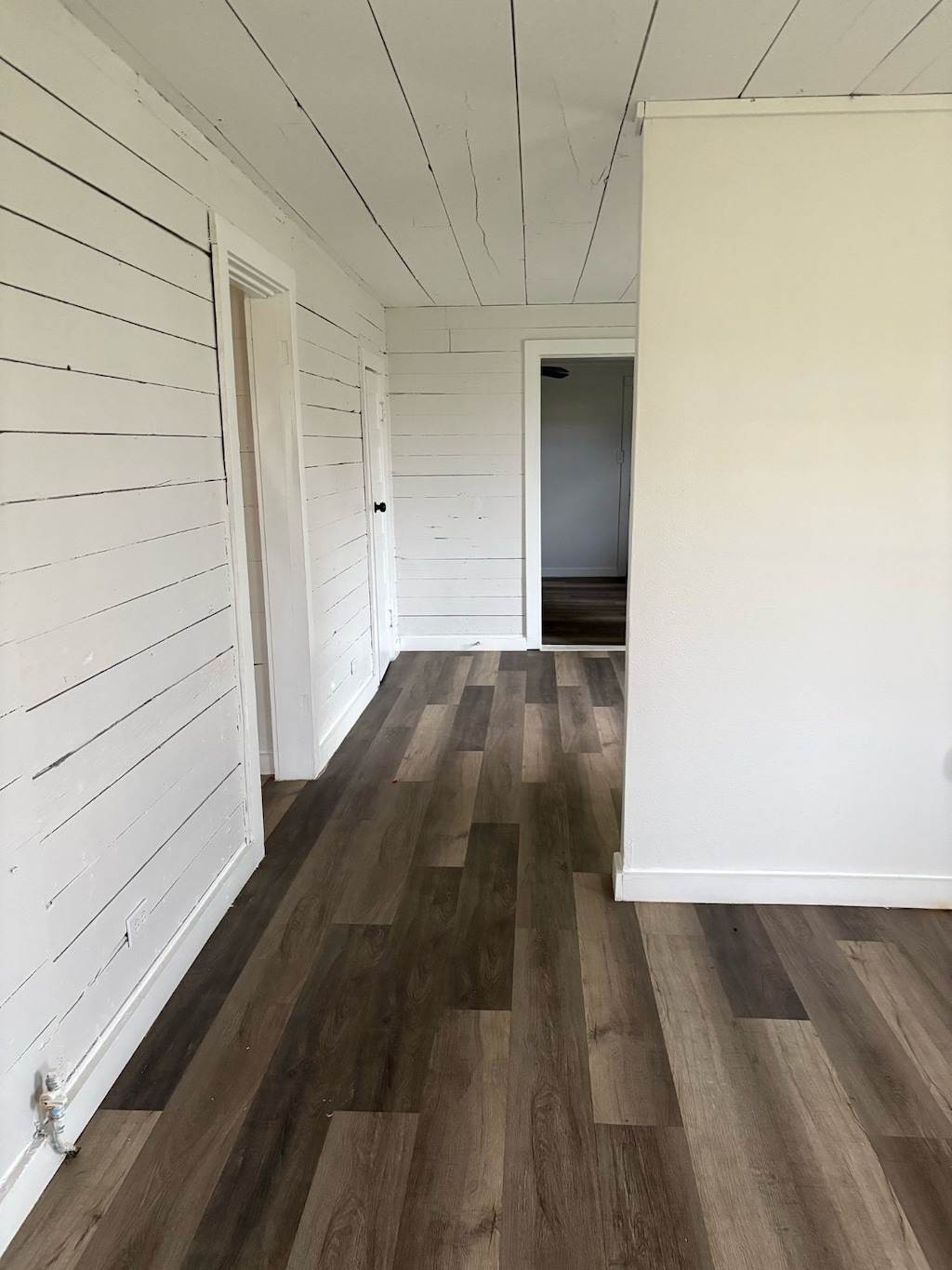 3709 N State Highway 91, Denison, TX 75020 - corridor with wood walls and dark wood-style flooring