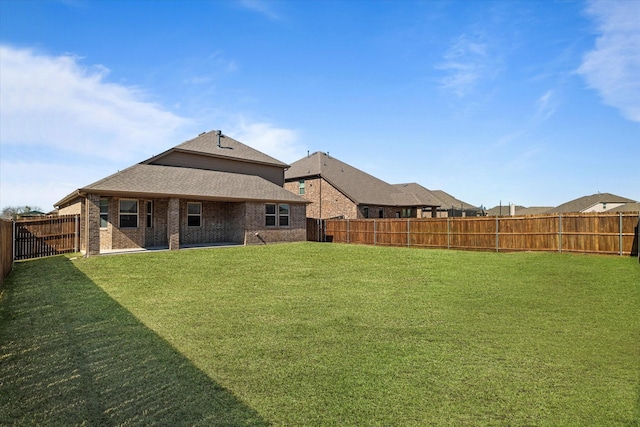 1008 Sublime Dr, Heath, TX 75126 - rear view of house with a fenced backyard, a shingled roof, a yard, and brick siding