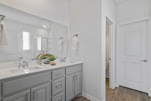 1008 Sublime Dr, Heath, TX 75126 - bathroom featuring double vanity, toilet, a sink, and a stall shower