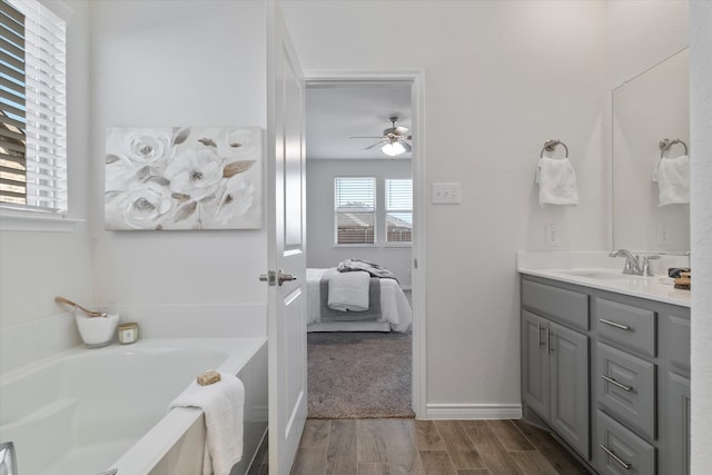1008 Sublime Dr, Heath, TX 75126 - ensuite bathroom with ceiling fan, ensuite bath, vanity, wood finished floors, and a garden tub