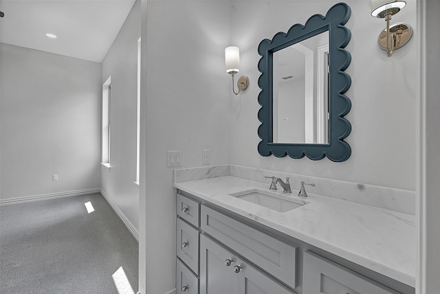 bathroom with vanity and baseboards