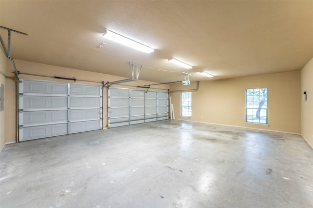 garage featuring baseboards and electric panel
