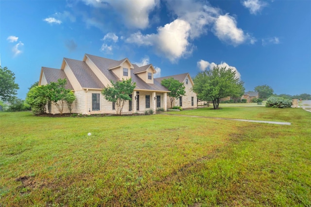 view of front of home with a front lawn and stone siding