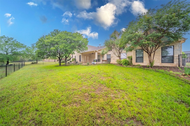 view of yard with fence and ceiling fan