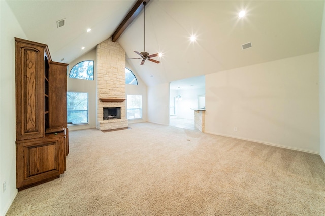 unfurnished living room with light carpet, beam ceiling, a fireplace, high vaulted ceiling, and a ceiling fan