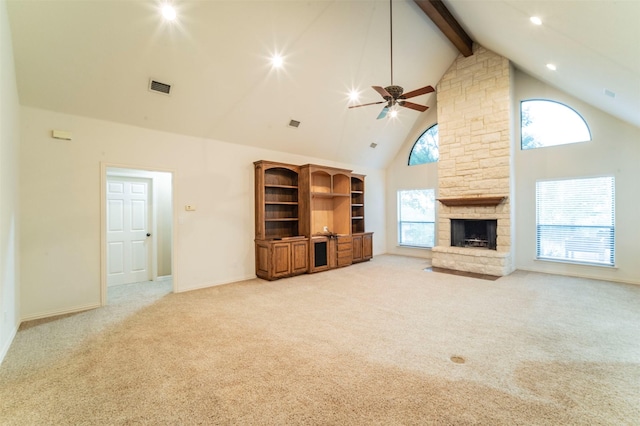 unfurnished living room with light carpet, high vaulted ceiling, a ceiling fan, beamed ceiling, and visible vents