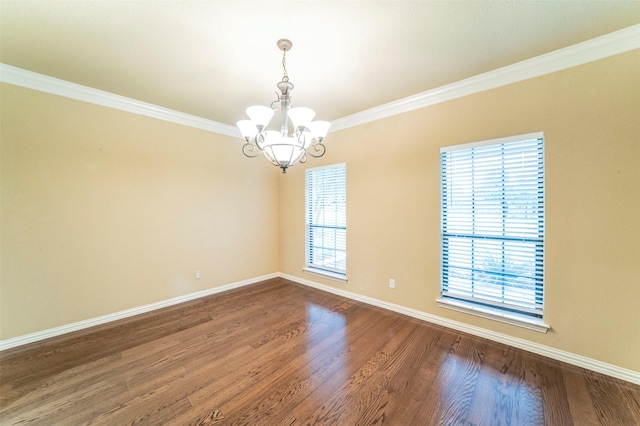 unfurnished room with an inviting chandelier, ornamental molding, baseboards, and dark wood finished floors