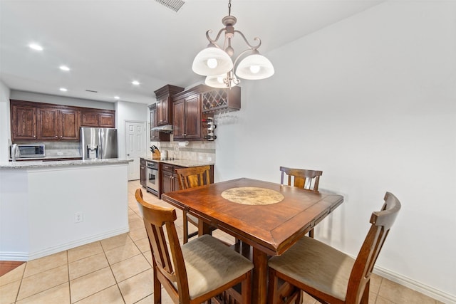 dining area featuring light tile patterned floors, baseboards, recessed lighting, and visible vents