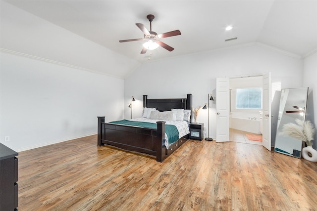 bedroom with ceiling fan, vaulted ceiling, light wood-style flooring, and visible vents