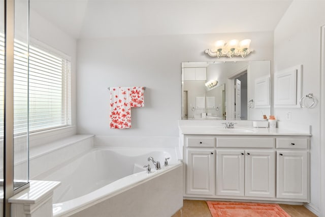 bathroom featuring vanity, tile patterned floors, and a garden tub