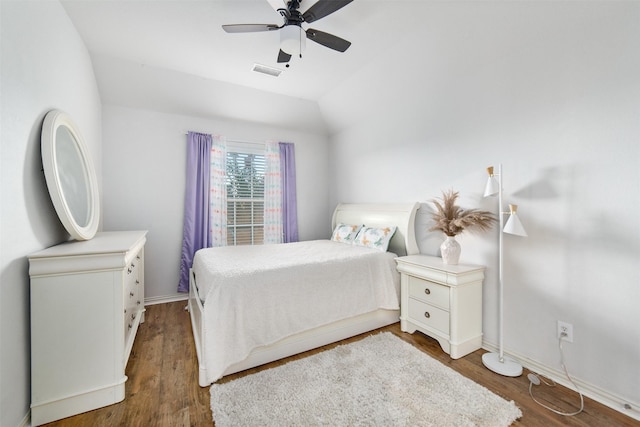 bedroom featuring ceiling fan, lofted ceiling, wood finished floors, and visible vents