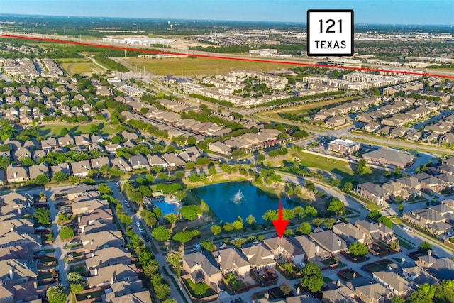 birds eye view of property featuring a water view and a residential view