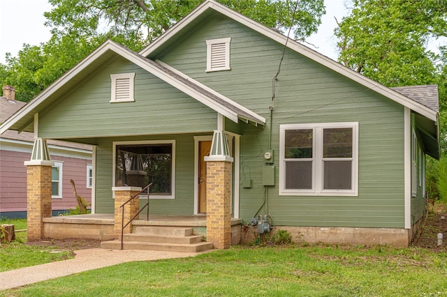 view of front of house featuring a front lawn and covered porch