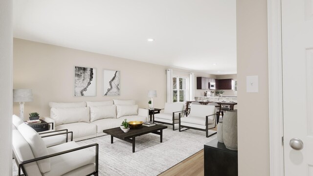 living area with light wood-type flooring and recessed lighting