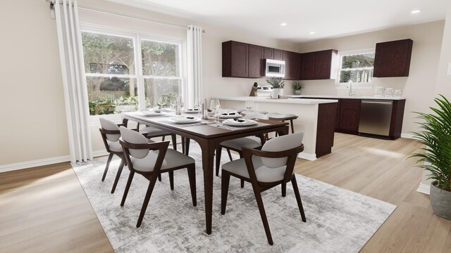 dining space featuring recessed lighting, baseboards, and light wood finished floors