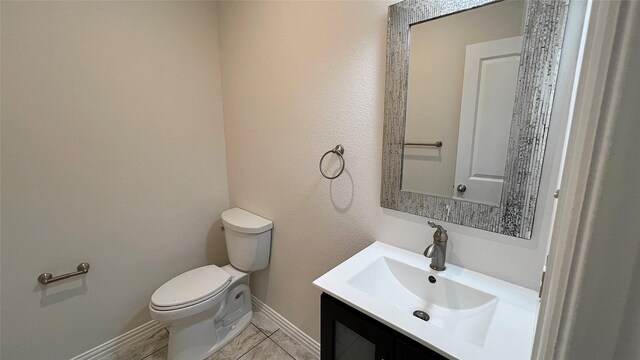 bathroom featuring vanity, baseboards, and toilet