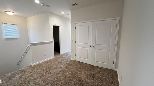 carpeted spare room featuring recessed lighting, baseboards, and visible vents