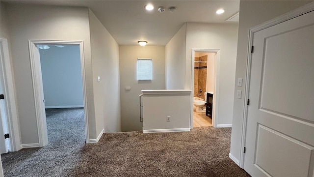 hall featuring recessed lighting, baseboards, and carpet