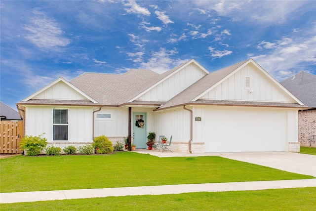view of front facade with fence, a front lawn, a garage, board and batten siding, and concrete driveway