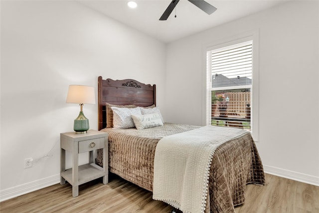 bedroom featuring baseboards, ceiling fan, and wood finished floors