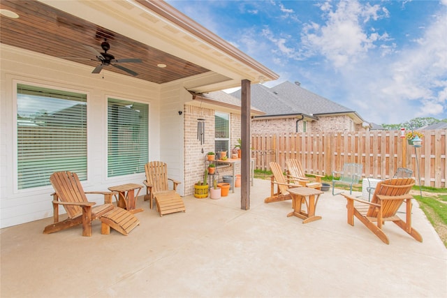 view of patio with fence and a ceiling fan
