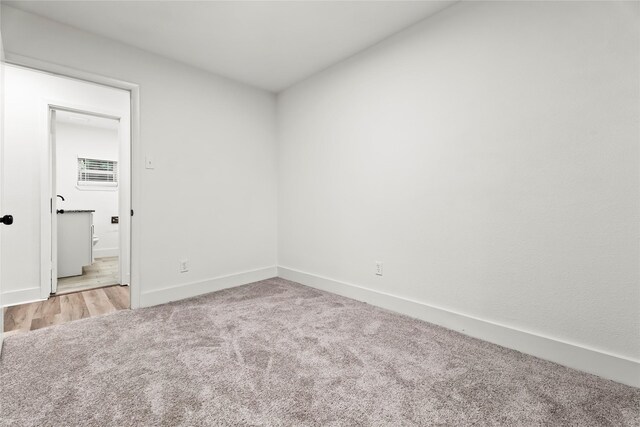 unfurnished bedroom with baseboards and carpet