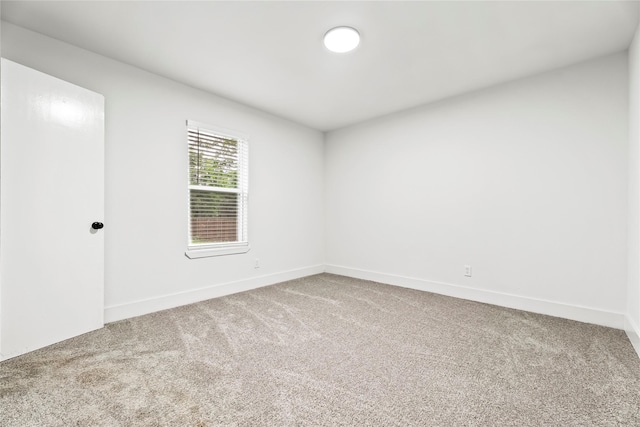 carpeted empty room with baseboards