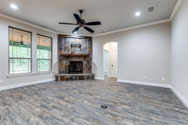 580 Leatherwood Ln, Poolville, TX 76487 - unfurnished living room featuring ceiling fan, visible vents, arched walkways, wood finished floors, and ornamental molding