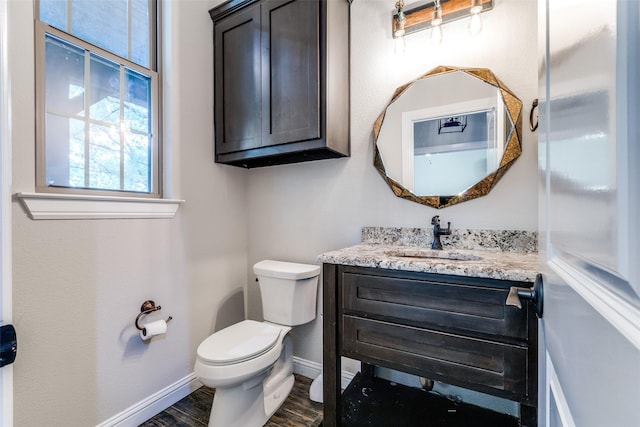 580 Leatherwood Ln, Poolville, TX 76487 - half bathroom featuring baseboards, vanity, toilet, and wood finished floors