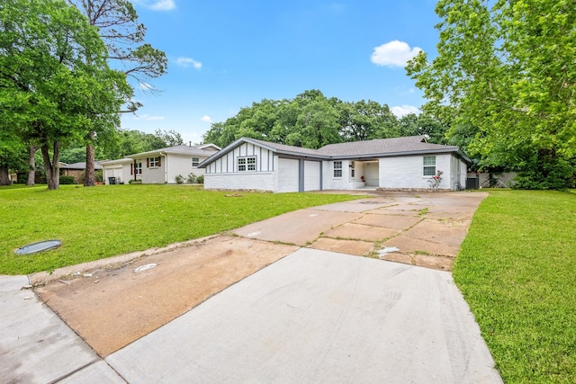 ranch-style house with board and batten siding, an attached garage, concrete driveway, and a front lawn