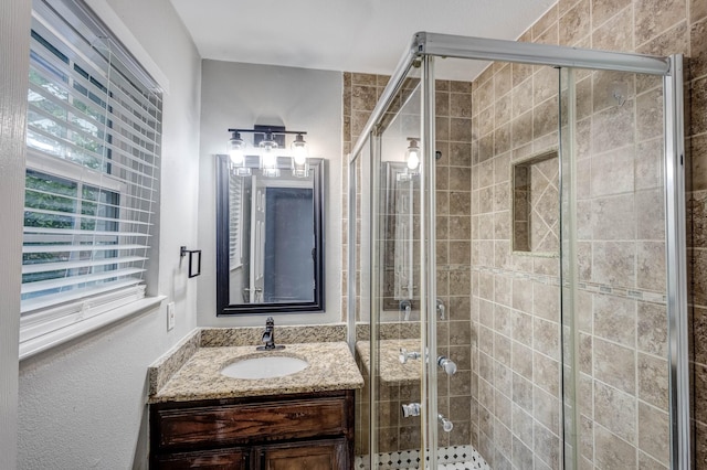 full bath featuring vanity and a shower stall