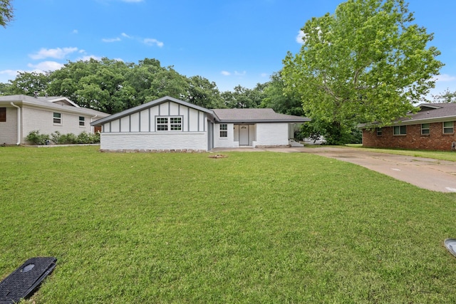 ranch-style home featuring a garage, board and batten siding, driveway, and a front yard