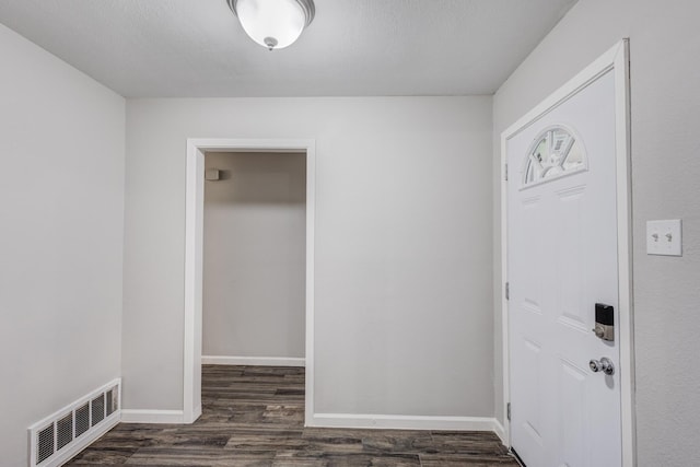 entrance foyer with baseboards, dark wood-style flooring, and visible vents