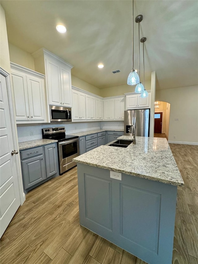 kitchen featuring visible vents, white cabinetry, a sink, appliances with stainless steel finishes, and gray cabinetry