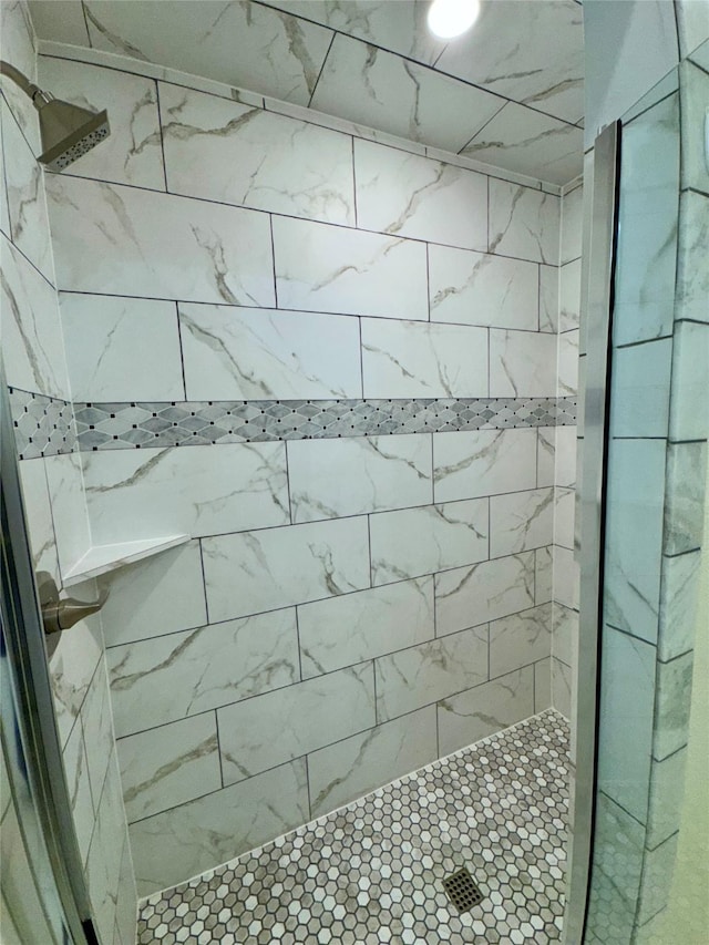 bathroom with a tile shower