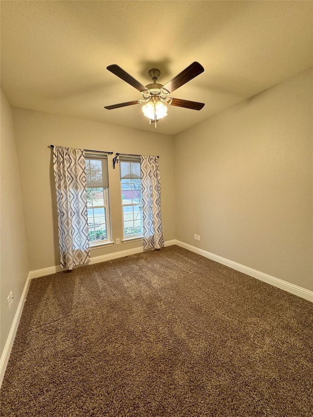 unfurnished room featuring ceiling fan, baseboards, and dark colored carpet