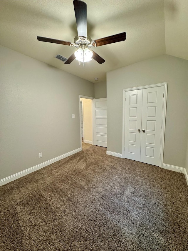 unfurnished bedroom with carpet floors, baseboards, ceiling fan, and visible vents