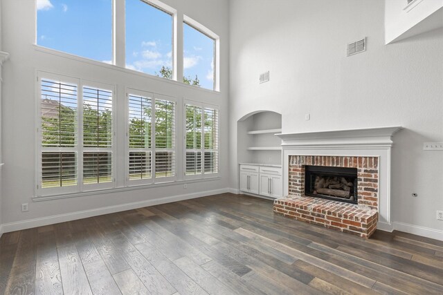 821 High Willow Dr, Prosper, TX 75078 - unfurnished living room with baseboards, dark wood-style flooring, built in shelves, and visible vents