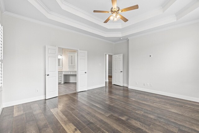 821 High Willow Dr, Prosper, TX 75078 - unfurnished bedroom with crown molding, baseboards, connected bathroom, a tray ceiling, and dark wood finished floors
