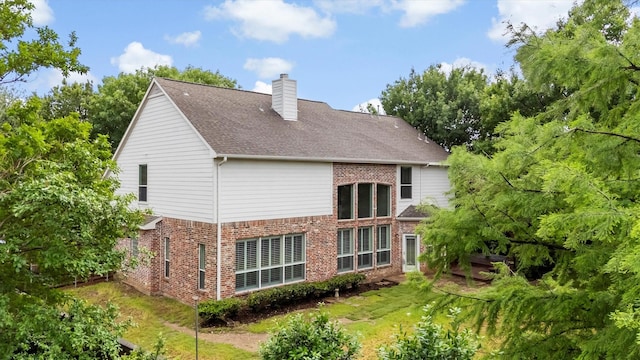 821 High Willow Dr, Prosper, TX 75078 - rear view of house with brick siding, a chimney, and a shingled roof