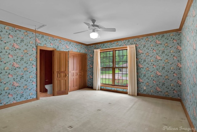 unfurnished bedroom with crown molding, wallpapered walls, carpet floors, and attic access