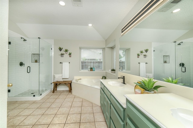 full bathroom featuring vanity, vaulted ceiling, a garden tub, and visible vents