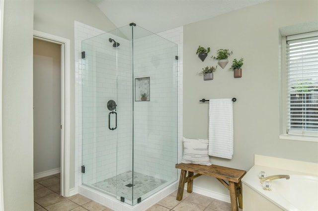 bathroom with baseboards and a shower stall
