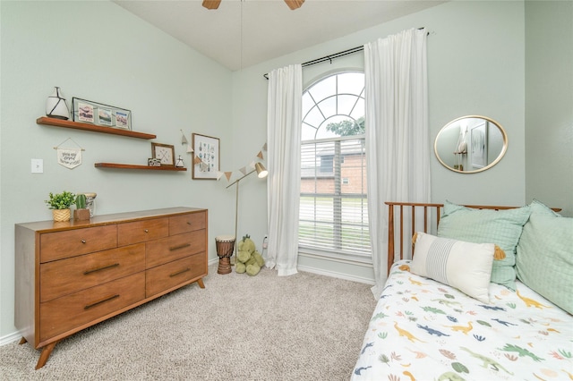 bedroom with baseboards, ceiling fan, and light carpet