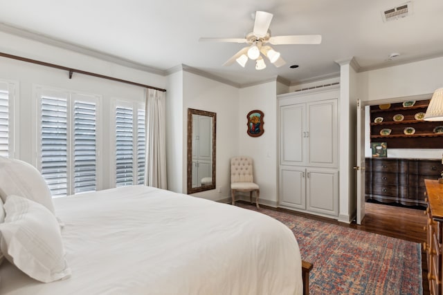 bedroom with dark wood-style flooring, a ceiling fan, visible vents, and ornamental molding