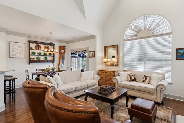living area with crown molding, a chandelier, baseboards, vaulted ceiling, and dark wood-style floors