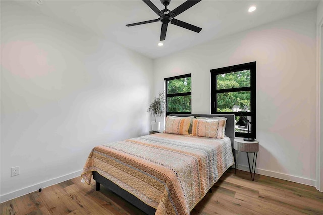 bedroom featuring recessed lighting, baseboards, ceiling fan, and wood finished floors