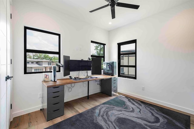 office featuring baseboards, a ceiling fan, light wood-style flooring, and recessed lighting